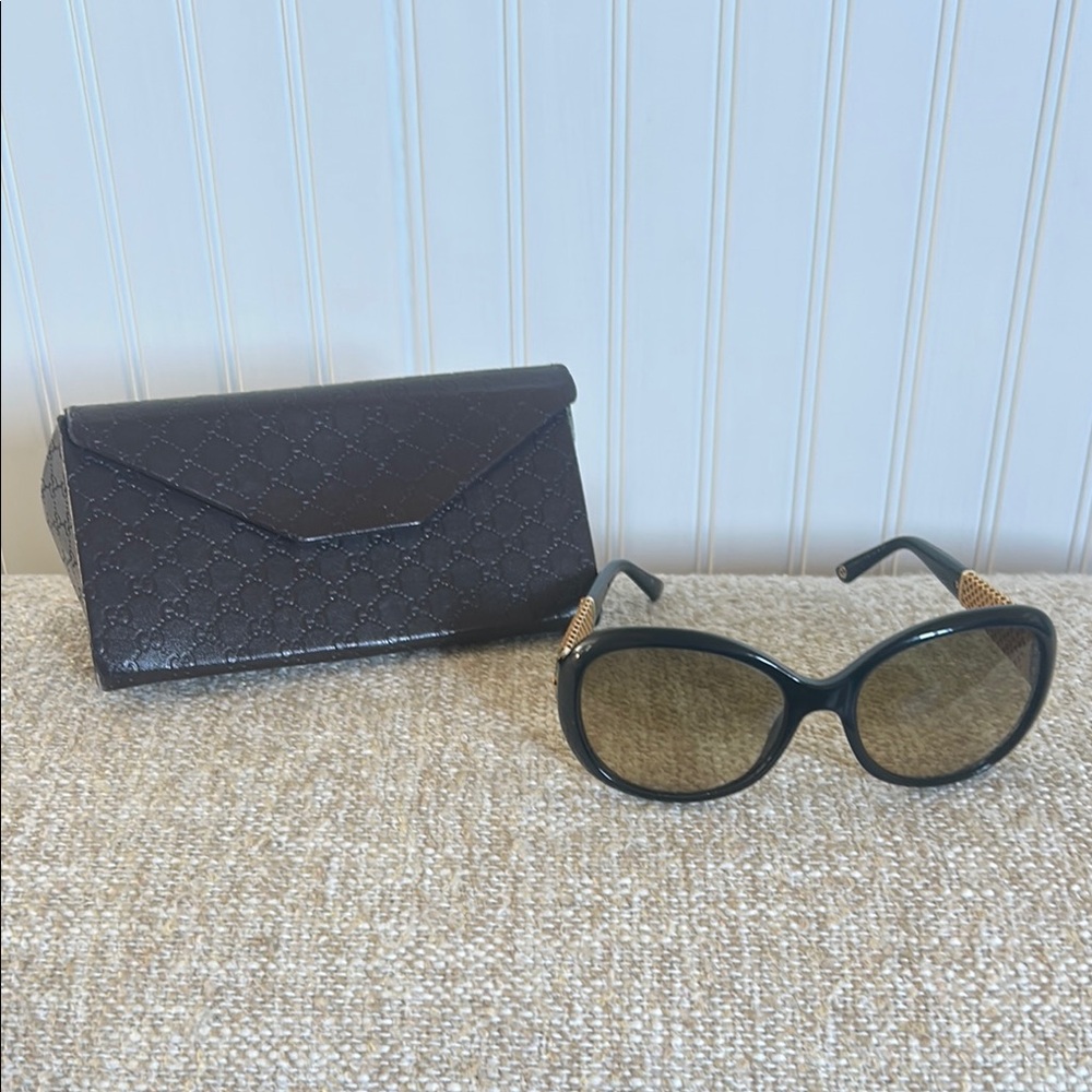 Authentic Gucci Elegant Black Sunglasses with Gold plated temples.